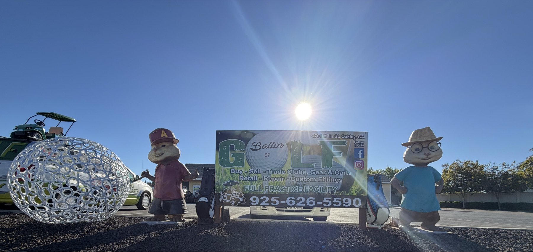 GolfBallin storefront with the shop sign and mascots out front — buy, sell, trade and full practice facility