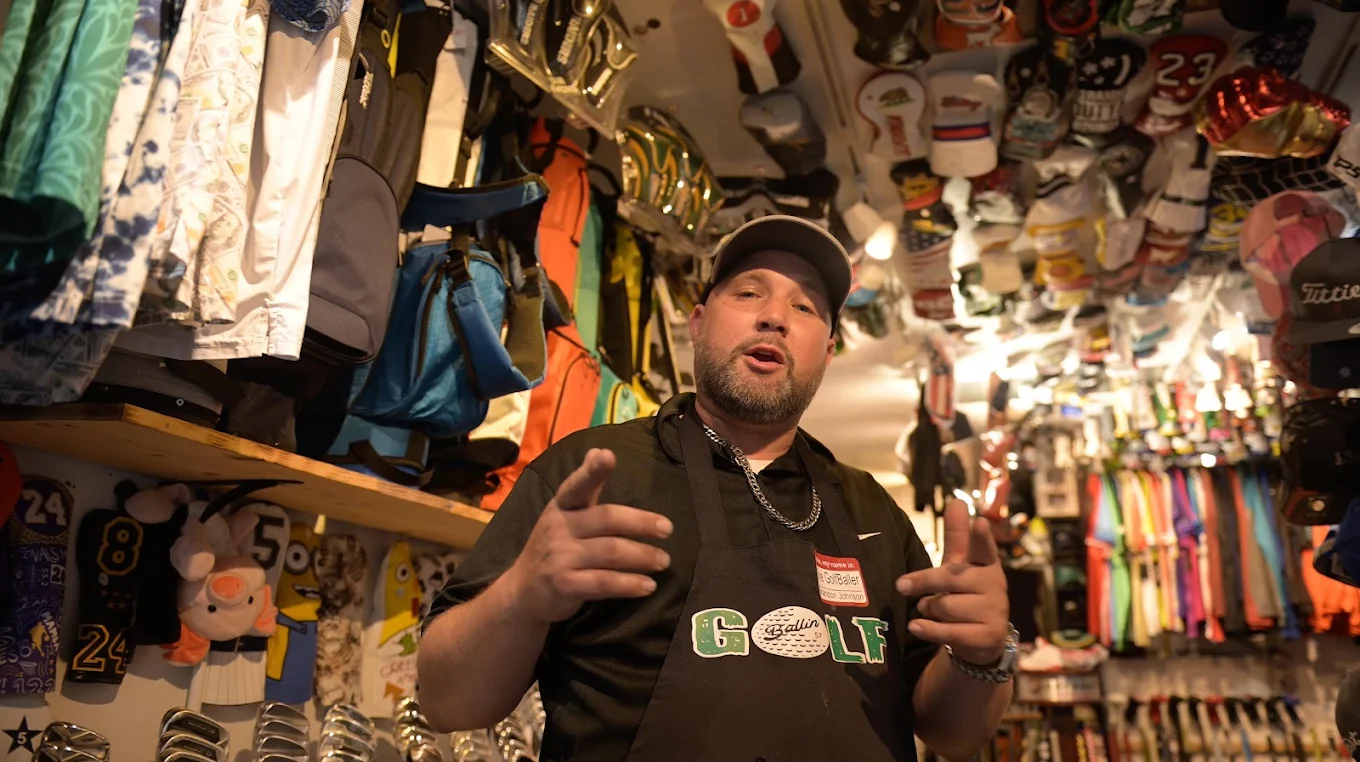 Brandon, the owner of GolfBallin, talking with his hands in the pro shop